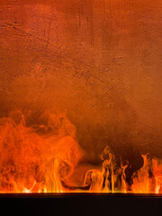 Bright flame against a concrete wall