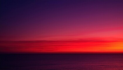 Fototapeta premium Dramatic Sunset Over Ocean Horizon with Vibrant Red, Purple, and Pink Clouds Illuminating the Sky. Ideal for Travel, Nature, Meditation, and Inspirational Background Concepts