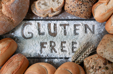 gluten free breads, glutenfree word written and bread rolls on grey background