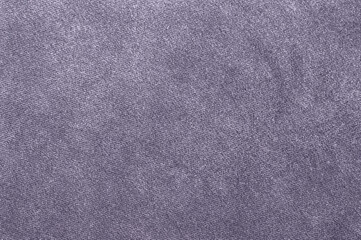 Close-up of a plain pastel lilac fabric texture with a uniform, woven appearance.