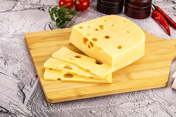 Maasdam cheese piece with slices
