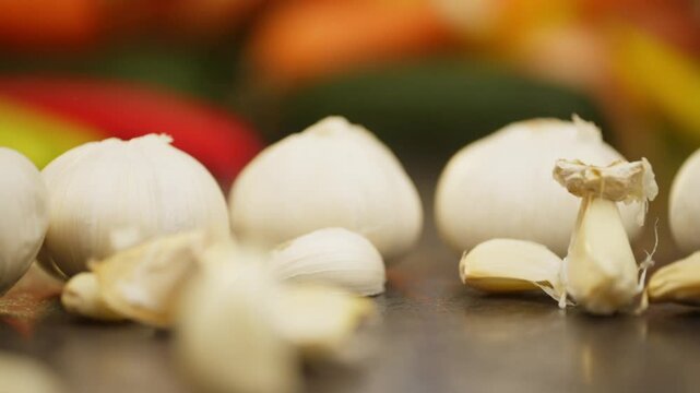 Close up slow motion video of fresh garlic falling on the table. Farmed organic vegetables for cooking. High quality FullHD footage