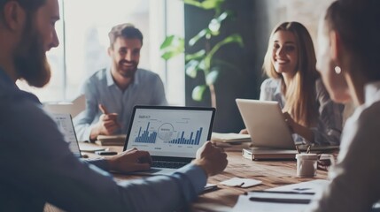 Fototapeta premium Marketing team discussing campaign performance on digital devices in a modern office