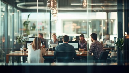A diverse team of professionals engaged in a collaborative workspace, discussing ideas and strategies while utilizing modern technology in an inspiring office environment.