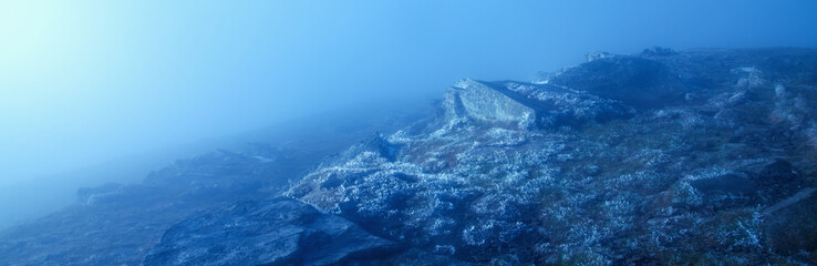 Fototapeta premium Landscape of mountain with clouds and nebula. Horizontal image.