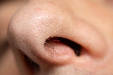 Caucasian man open nose, looking up, macro close up shot, unrecognizable