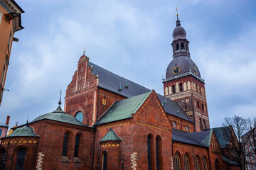 Historic Riga Cathedral with impressive architecture against a cloudy sky during late afternoon in Latvia