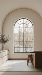A modern minimalist kitchen with an arched window that overlooks a natural scenery.