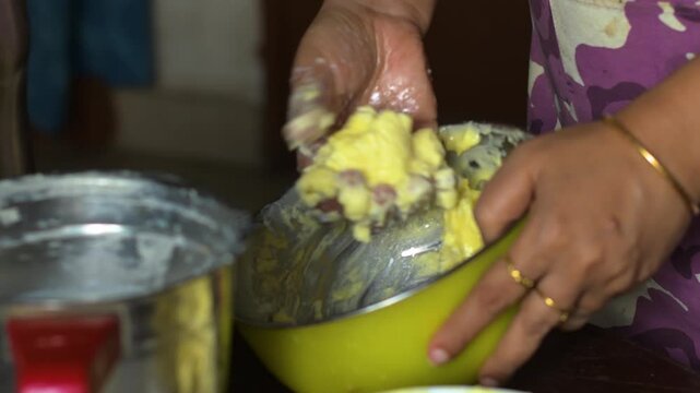 Young woman processing fresh cream from milk to make ghee at home