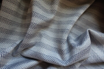 Striped ornamental cotton fabric in shades of grey in soft folds