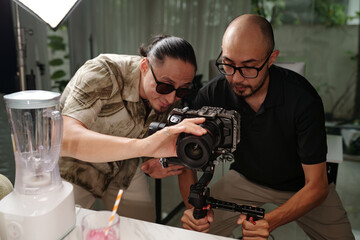 Director leading the process of shooting while cameraman using his camera