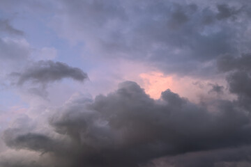 Overcast sky with dramatic cloud formations and a hint of pink from the setting sun, ideal for use as a background or sky replacement in projects needing a sunset ambiance