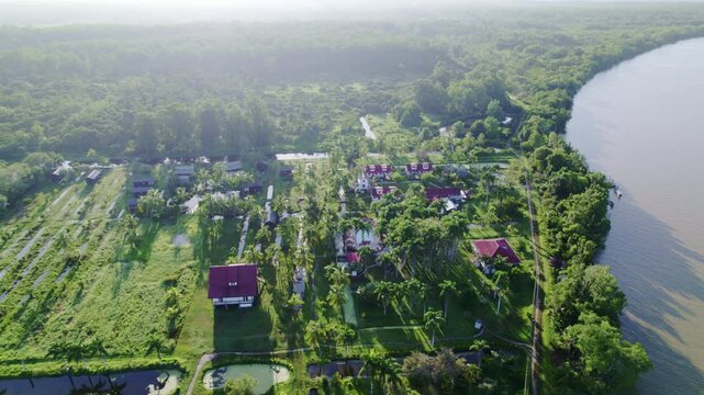 Drone fly over commewijne river, view of Frederiksdorp village, Suriname