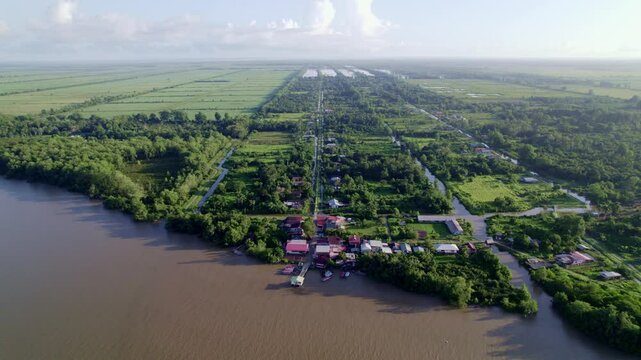 Fly over rural village by commewijne river, Johan and Margaretha plantation, village reveal, Suriname