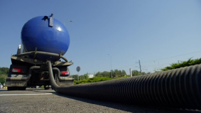 A truck for pumping out waste is pumping from the sewer. Waste treatment and treatment facilities. High quality 4k footage