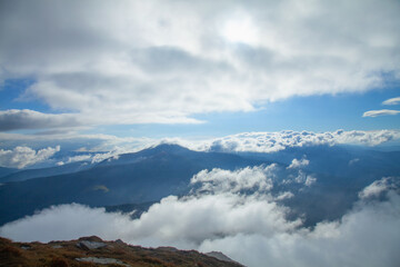 Between heaven and earth. Fog, clouds and nebula and clouds in the mountains. Horizontal image.
