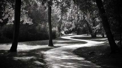 A winding path in the park leads through the trees, disappearing into the distance.