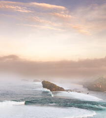 A breathtaking panorama of a secluded beach, shrouded in mist and bathed in golden light. © AniciCreativeMedia 