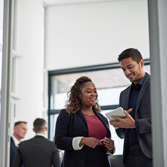 Smile, tablet and business people in office with advice, ideas or planning online report together. Man, woman and digital app in meeting for discussion, schedule or support in teamwork with low angle