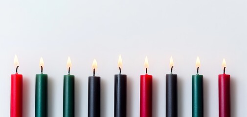 Kwanzaa candles lit in red, black, and green
