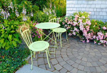 Two garden chairs in a courtyard garden 