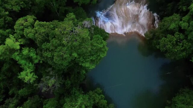 Topdown aerial footage over a blue river and wtaerfalls surrounded by lush jungle, Roberto Barrios, Chiapas, Mexico