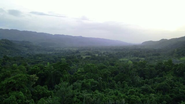 Aerial drone footage over river a lush jungle valley at sunset, Roberto Barrios, Chiapas, Mexico