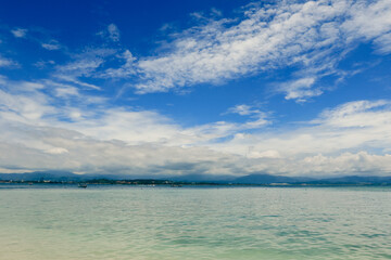 Beautiful scenic view of Mamutik Island’s turquoise waters and cloudy skies in Malaysia on a calm day