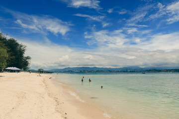 Relaxing beach day on Mamutik Island in Malaysia with clear waters and beautiful skies