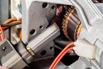 Replacing graphite electric motor brushes, close-up, industry. Copy space for text