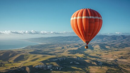Naklejka premium A vibrant hot air balloon soaring over scenic landscapes.