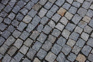 Granite cobblestone pavement forming textured background Karlin, Prague