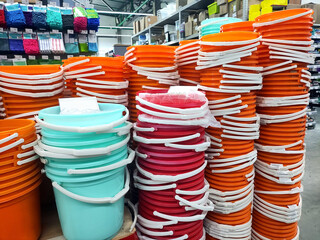 Selling a lot of plastic multi-colored buckets in a department store, close-up, background