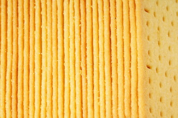 Rectangular, savory salty cheese-flavored biscuits with a golden-yellow color, neatly stacked. Perfect as a snack. Photographed on a white background.