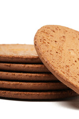 Round, flat chocolate-flavored crackers with a brown color, neatly stacked. Perfect as a snack. Photographed on a white background.