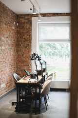 Nail salon loft interior. View of modern manicure shop. Inside beauty studio interior design. Clean empty trendy nail salon.