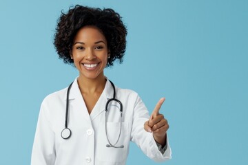 Smiling female doctor in white coat with stethoscope gesturing against blue background. healthcare, professionalism, and medical expertise.