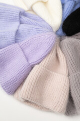Collection of stylish knitted hats (pink, beige, black, white, gray, red) Composition of lined hats. A set of autumn - winter hat accessories