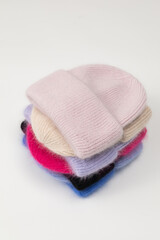 Collection of stylish knitted hats (pink, beige, black, white, gray, red) Composition of lined hats. A set of autumn - winter hat accessories