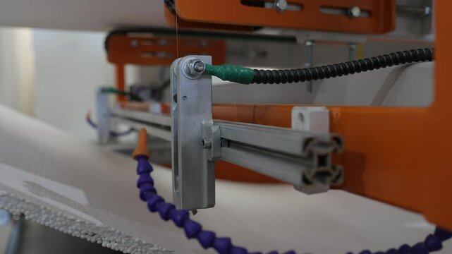 Industrial footage of a laser cutting foam at a factory. The precision laser slices through the material smoothly, demonstrating efficient manufacturing processes production technology in action