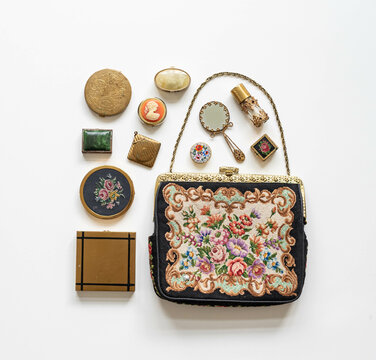 Antique embroidered clutch handbag with old accessories, mirror, perfume, small pill boxes, powder boxes
