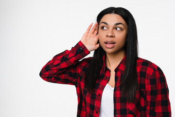 Curious nosy African American girl woman female student touch ear doing eavesdropping look novelty,...