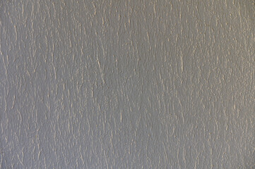 A Textured Wall Displaying Subtle Shades and Patterns Under Soft Natural Light in a Serene Indoor...