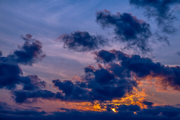 Colourful golden sunset with lively clouds.