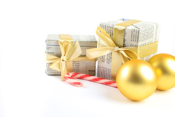 Gifts wrapped in old newspaper on white background