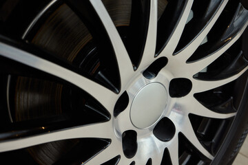 Detailed shot of a sleek black and silver alloy wheel on a motor vehicle