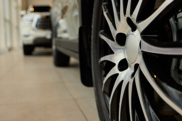 Detailed shot of a sleek black and silver alloy wheel on a motor vehicle
