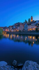 Obraz premium European Town with River at Dusk and Reflected Lights