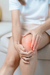 woman having knee ache and muscle pain due to Runners Knee or Patellofemoral Pain Syndrome,...