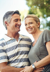 Obraz premium Happy, hug and mature couple in nature at park for bonding, marriage and connection in morning. Outdoor, smile and man and woman embracing in garden for romance on date with love and care together.